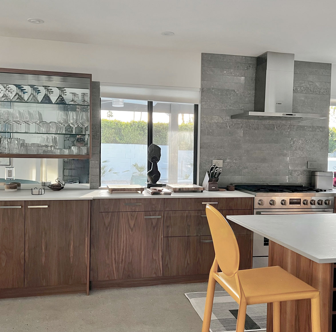 Kitchen with wood grain cabinets and stone tile background